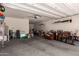 Spacious garage with ample storage space, including overhead racks and shelving at 34009 N 29Th Dr, Phoenix, AZ 85085