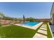 Sparkling swimming pool with lush landscaping, stone-paved walkway, and privacy fencing at 34009 N 29Th Dr, Phoenix, AZ 85085