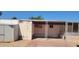 Exterior view of the side of the home with an attached shed and covered parking area, ready for renovation at 3541 W Monona Dr, Glendale, AZ 85308