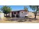 Home's exterior showcasing a side entrance and partial fencing, providing potential for a cozy, private setting at 3541 W Monona Dr, Glendale, AZ 85308