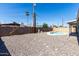 Backyard featuring gravel landscaping and a pool with patio surround at 3811 W Loma Ln, Phoenix, AZ 85051