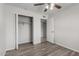 Bedroom with wood-look flooring, standard closet and closet organizer at 3811 W Loma Ln, Phoenix, AZ 85051