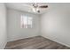 Bedroom featuring a ceiling fan, light and neutral paint, and wood-look flooring at 3811 W Loma Ln, Phoenix, AZ 85051