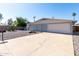 Spacious driveway leading to a single-story home with desert landscaping and an attached two-car garage at 3811 W Loma Ln, Phoenix, AZ 85051