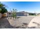 View of the front yard with desert landscaping and a single-story home featuring a two-car garage at 3811 W Loma Ln, Phoenix, AZ 85051