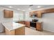 Updated kitchen featuring granite countertops, wood cabinets, and stainless steel appliances at 3811 W Loma Ln, Phoenix, AZ 85051
