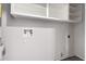 Laundry room with utility sink and overhead shelving at 3811 W Loma Ln, Phoenix, AZ 85051