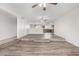 Expansive living room with laminate flooring, ceiling fan and seamless flow into the open kitchen at 3811 W Loma Ln, Phoenix, AZ 85051