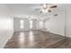Spacious living room featuring two ceiling fans, laminate flooring and two large windows for natural light at 3811 W Loma Ln, Phoenix, AZ 85051