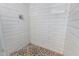 Bathroom shower featuring tiled walls and mosaic tile floor at 3811 W Loma Ln, Phoenix, AZ 85051