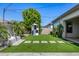 Backyard with artificial grass, play structure, and elegant stone pavers at 3822 E Canyon Pl, Chandler, AZ 85249
