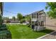 Large backyard with lush artificial turf, a modern playhouse, and a cozy fire pit area at 3822 E Canyon Pl, Chandler, AZ 85249
