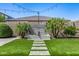 Beautiful backyard featuring a serene water feature, lush turf, and string lights for a peaceful ambiance at 3822 E Canyon Pl, Chandler, AZ 85249