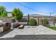 Relaxing backyard featuring built-in barbecue, comfortable seating around a fire pit, and green turf at 3822 E Canyon Pl, Chandler, AZ 85249