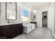 Spa bathroom featuring freestanding tub, dual vanities, and tiled floors at 3822 E Canyon Pl, Chandler, AZ 85249