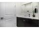 Modern bathroom with dark wood cabinets, white countertops, and contemporary fixtures at 3822 E Canyon Pl, Chandler, AZ 85249