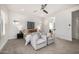 Bright primary bedroom with seating area, ceiling fan, and natural light at 3822 E Canyon Pl, Chandler, AZ 85249