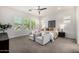 Bright bedroom with plush chairs, ceiling fan and natural light coming through the shutters at 3822 E Canyon Pl, Chandler, AZ 85249