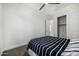 Bedroom features carpet, ceiling fan, closet, and a white/black striped comforter at 3822 E Canyon Pl, Chandler, AZ 85249