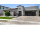 Contemporary home featuring desert landscaping, a modern facade, a tile roof and a three-car garage at 3822 E Canyon Pl, Chandler, AZ 85249