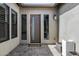 Modern front door with sidelight windows and a stone-paved entryway under a covered porch at 3822 E Canyon Pl, Chandler, AZ 85249