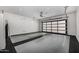 Spacious garage with gray flooring and a full glass-paned garage door to welcome natural light at 3822 E Canyon Pl, Chandler, AZ 85249