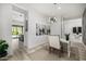 Modern dining area with a stylish light fixture, neutral decor, and an open view to the kitchen at 3822 E Canyon Pl, Chandler, AZ 85249