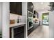 Modern kitchen with a wine fridge, stainless steel appliances, dark cabinets, and ample counter space at 3822 E Canyon Pl, Chandler, AZ 85249