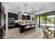 Spacious kitchen island with seating, modern lighting, and stainless steel appliances overlooking a patio at 3822 E Canyon Pl, Chandler, AZ 85249