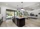 Open-concept kitchen with a large island, stainless steel appliances, and sliding glass doors to the backyard at 3822 E Canyon Pl, Chandler, AZ 85249