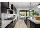 Modern kitchen with dark cabinetry, stainless steel appliances, and a sliding glass door to the backyard at 3822 E Canyon Pl, Chandler, AZ 85249