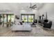 Open-concept living room featuring high ceilings, a ceiling fan, and sliding glass doors to the backyard at 3822 E Canyon Pl, Chandler, AZ 85249