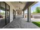 Covered patio with gray pavers features an outdoor kitchen, a ceiling fan, and a television at 3822 E Canyon Pl, Chandler, AZ 85249