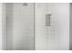 Walk-in shower featuring white subway tile, glass surround, and built-in niche at 3822 E Canyon Pl, Chandler, AZ 85249