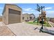 Paver patio with a play structure, basketball hoop, and artificial grass at 4091 W Suncup Dr, San Tan Valley, AZ 85144