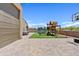 Large backyard with paver patio, play structure, and trampoline at 4091 W Suncup Dr, San Tan Valley, AZ 85144