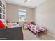 Bedroom featuring two twin beds, gray walls, and natural light at 4091 W Suncup Dr, San Tan Valley, AZ 85144