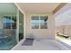 Spacious covered patio featuring a sliding glass door, neutral color palette, and backyard views at 4091 W Suncup Dr, San Tan Valley, AZ 85144