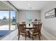 Bright dining area with a wooden table, seating for six, and sliding glass doors to the backyard at 4091 W Suncup Dr, San Tan Valley, AZ 85144