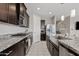 Galley kitchen showcasing stainless steel appliances and ample counter space for cooking at 4091 W Suncup Dr, San Tan Valley, AZ 85144