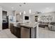 Open kitchen with stainless steel appliances, a central island, and a view of the living room at 4091 W Suncup Dr, San Tan Valley, AZ 85144