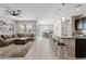 Open-concept living room with kitchen island, dining area, and comfortable seating at 4091 W Suncup Dr, San Tan Valley, AZ 85144