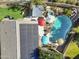 Aerial view of home with backyard oasis, including pool, hot tub, solar panels, and green space at 4111 S Dewdrop Ct, Gilbert, AZ 85297