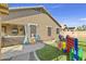 Beautiful backyard with an outdoor living space, artificial turf, and play area at 4111 S Dewdrop Ct, Gilbert, AZ 85297