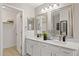 Bright bathroom with double sinks, white cabinets, and granite countertops at 4111 S Dewdrop Ct, Gilbert, AZ 85297