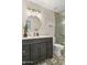 Bathroom with decorative tile floors, dark wood cabinet, a round mirror and a glass shower at 4111 S Dewdrop Ct, Gilbert, AZ 85297
