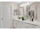 Bright bathroom with double sinks, white cabinets, and granite countertops at 4111 S Dewdrop Ct, Gilbert, AZ 85297