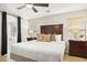 Cozy bedroom with a king bed, wood floors, and an ensuite bathroom at 4111 S Dewdrop Ct, Gilbert, AZ 85297