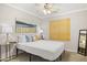 This bedroom features a ceiling fan, window with blinds, and stylish decor for a cozy and inviting atmosphere at 4111 S Dewdrop Ct, Gilbert, AZ 85297