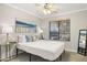 This bedroom features a ceiling fan, window with blinds, and stylish decor for a cozy and inviting atmosphere at 4111 S Dewdrop Ct, Gilbert, AZ 85297
